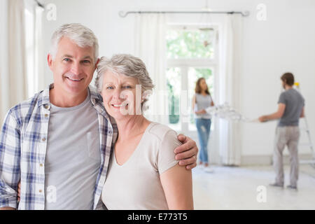 Anziana coppia sorridente insieme in uno spazio soggiorno Foto Stock