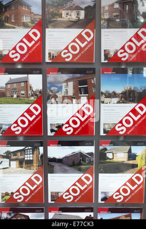 Una pensione completa di venduto casa segni nella finestra di Bairstow Vigilie di agenti immobiliari, Silver Street, Lincoln. Foto Stock