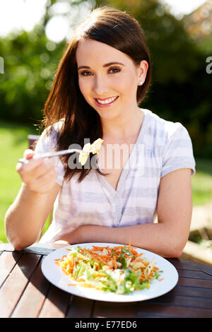 Bella ragazza mangiare sano pasto all'aperto Foto Stock