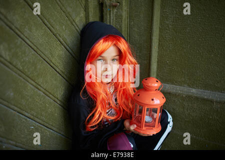 Ritratto di ragazza di Halloween holding lanterna con candela e guardando la fotocamera Foto Stock