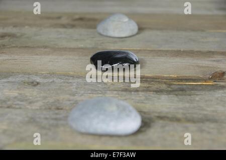 Tre Pietre sul pannello di legno Foto Stock