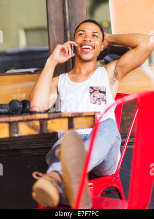 African American uomo parlando al cellulare al cafe Foto Stock