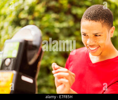 African American uomo parcheggio a pagamento metro Foto Stock