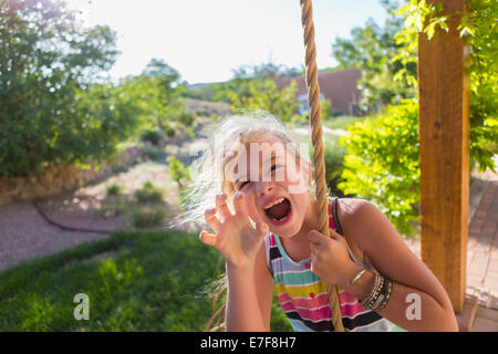 Ragazza caucasica giocando su swing corda Foto Stock