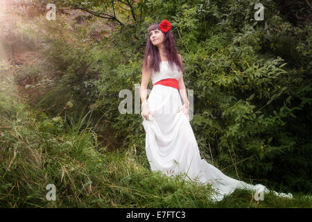 Ritratto di giovane e bella donna in abito bianco sulla natura Foto Stock