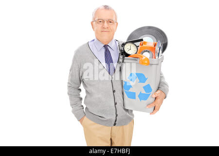 Senior man tenendo un cestino pieno di roba vecchia isolati su sfondo bianco Foto Stock