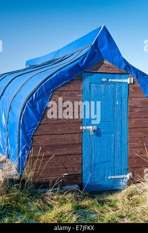 Rustico barca capovolta capannone dello scafo, Isola Santa, Northumberland, England, Regno Unito Foto Stock