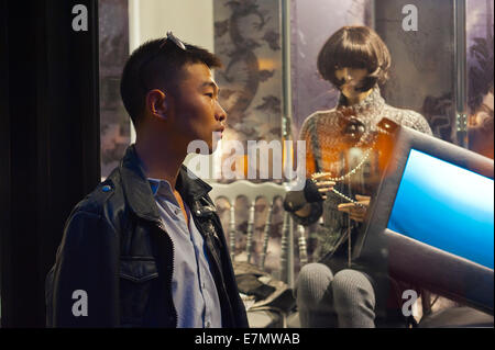 Parigi, Francia, giovane uomo cinese al di fuori del negozio di lusso di window shopping, notte Foto Stock