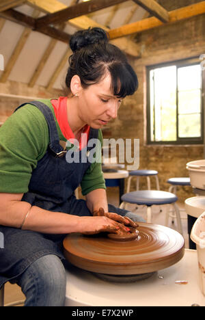 Donna dimostrando claybowl facendo sul lancio della ruota in corrispondenza di un patrimonio e di dimostrazione al giorno ad un ceramiche locali, farnham, surre Foto Stock