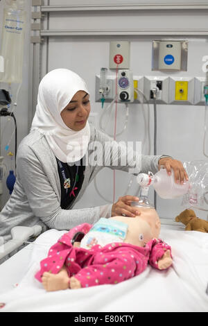 Calgary, Alberta, Canada, 27 settembre, 2014. Il dottor Amani Azizalrahman dimostra l'uso di un sistema computerizzato manichino pediatrico nel nuovo centro KidSIM all'Alberta ospedale per bambini durante le porte aperte YYC. La struttura all'avanguardia, la più grande simulazione pediatrica centro in Canada, fornisce i medici e le famiglie dei pazienti con la simulazione di una esperienza clinica quanto più vicino possibile a situazioni della vita reale. Foto Stock