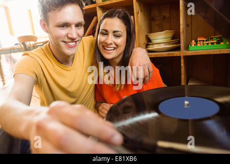 Coppia giovane mettendo su un disco in vinile Foto Stock