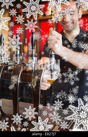 Immagine composita di bello barman tirando una pinta di birra Foto Stock