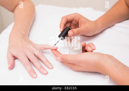 Chiodo tecnico del cliente dando una manicure Foto Stock