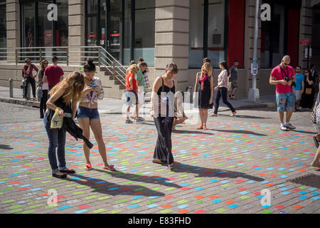 I visitatori del quartiere di Brooklyn di Dumbo visualizza 'generatori casuali serie" collocato sul selciato Foto Stock