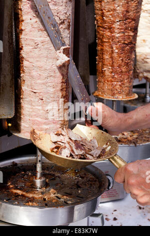 Bagno turco cook slicing Döner Kebab carne di sputare a un festival all'aperto - USA Foto Stock