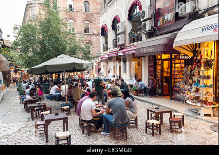 I giovani bevono il tè turco a Hazzopulo passaggio da Istiklal Caddesi, Beyoglu, Istanbul, Turchia Foto Stock