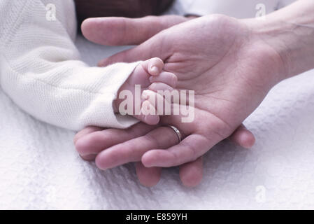 Close-up di baby la mano appoggiata su le mani dei genitori Foto Stock