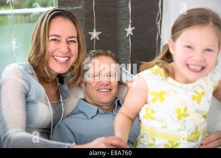 I genitori con la figlia seduta sul lettino divertendosi Foto Stock