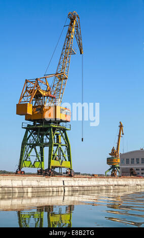 Grande porto industriale di gru funziona sul fiume costa nel porto bulgaro Foto Stock