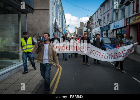 Pwllheli, Wales, Regno Unito. 4 Ottobre, 2014. Lingua gallese società (Cymdeithas yr Iaith Gymraeg) ha invitato le autorità locali e il Gallese di governo ad adottare le misure di pianificazione che trarrebbe vantaggio le necessità locali. Presidente della società JAMIE BEVAN conduce il rally e marcia di protesta a Pwllheli, il Galles del Nord, per sollevare la consapevolezza della loro campagna contro le attuali misure di pianificazione che essi sostengono che risulterebbe deleterio per la sostenibilità di Lingua gallese europee. Credito: Rhys Llwyd/Alamy Live News Foto Stock