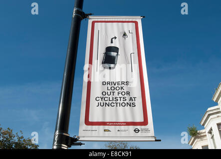 Banner firmare i driver di avvertimento di guardare fuori per i ciclisti in corrispondenza di giunzioni, Chiswick, Londra, Inghilterra Foto Stock