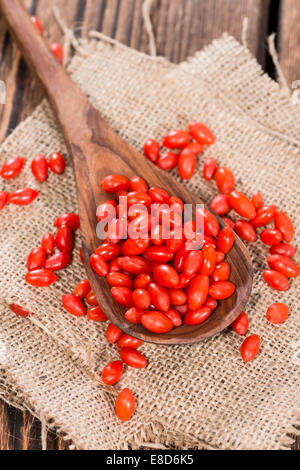 Porzione di fresche Bacche di Goji (Wolfberry) su un vintage cucchiaio di legno Foto Stock