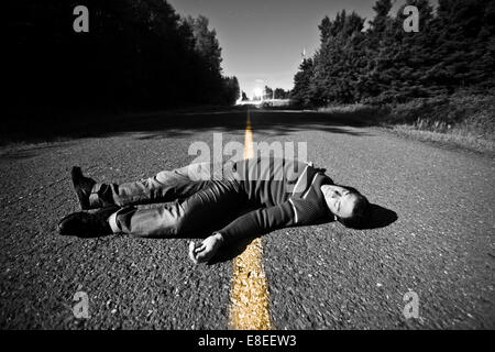 Strada vuota con corpo morto nel mezzo di notte Foto Stock