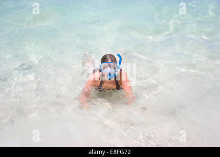 Donna in mare indossando maschera snorkel Foto Stock