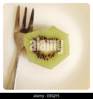 Il kiwi con forma di cuore i semi e la forcella Foto Stock
