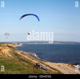 Parapendio volare sopra le scogliere di Barton on Sea Hampshire in una bella giornata d'estate con l'Isola di Wight in background Foto Stock