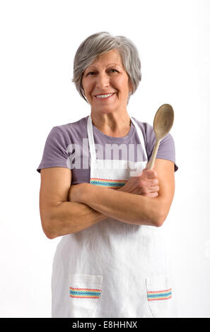 Signora senior con un cucchiaio di legno Foto Stock