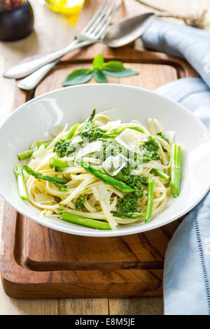 Fettuccine in pesto di asparagi con parmigiano di rasatura sulla parte superiore Foto Stock