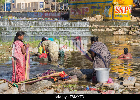 MADURAI INDIA MERIDIONALE giorno di lavaggio al fiume e battendo i vestiti sulle rocce Foto Stock