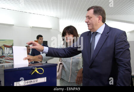 Banja Luka, Bosnia Erzegovina. Xii Ottobre, 2014. Serbo-bosniaco leader Milorad Dodik (R) e sua moglie votare in corrispondenza di una stazione di polling a Banja Luka, la capitale della Republika Srpska, l'entità della Bosnia ed Erzegovina. La Bosnia e Erzegovina ha dato dei calci a fuori la sua elezioni politiche di domenica mattina, la prima volta in quattro anni. Il paese è diviso in due auto-somministrazione di regioni. Credito: Xinhua/Alamy Live News Foto Stock