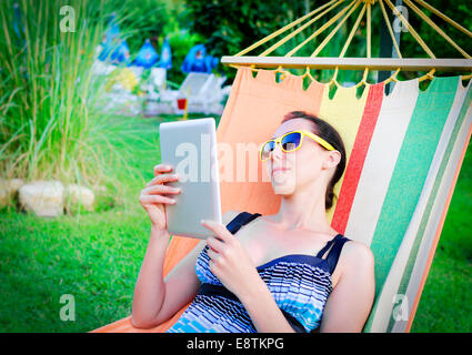 Donna relax In Amaca con Tablet PC Foto Stock