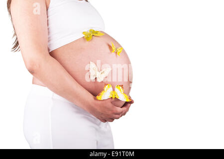 Bella donna incinta con farfalle Foto Stock