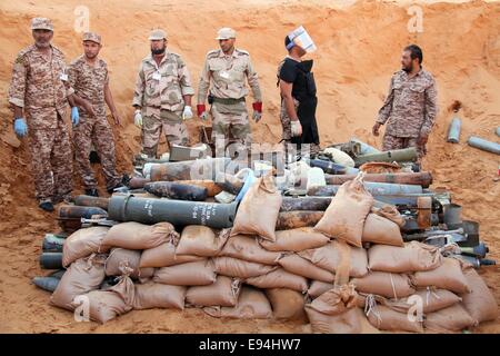 Tripoli, Libia. Xix oct, 2014. I sappers e alcuni soldati controllare i gusci inesplose vicino a Tripoli, in Libia, il Ott 19, 2014. Un team della Libyan sappers domenica raccolti e la detonazione di un lotto di ordigni gusci lasciati dai belligeranti gruppi militanti nei pressi della capitale città di Tripoli. Credito: Hamza Turkia/Xinhua/Alamy Live News Foto Stock