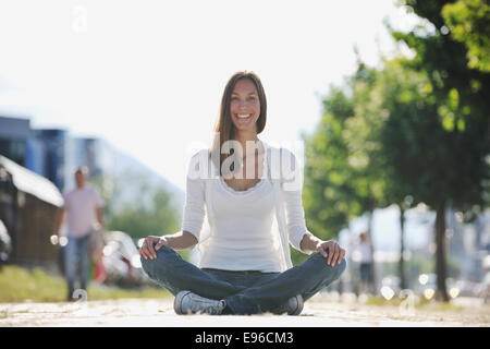 Lo yoga a sunny street Foto Stock