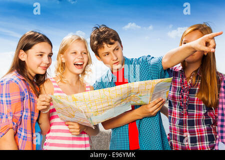 Guy punti con altri bambini insieme permanente Foto Stock