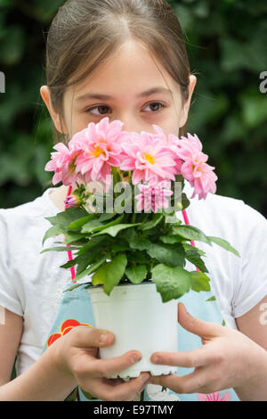 Ragazza con Vaso con fiori in mani Foto Stock