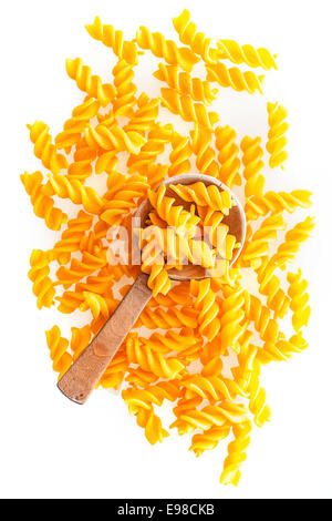 Materie italiano la pasta a spirale e un cucchiaio di legno, close-up shot da angolo alto, su sfondo bianco Foto Stock