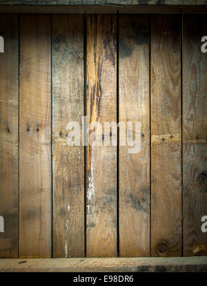 Texture di sfondo di un grungy macchiato e weathered tavolo in legno top con una linea di vecchi chiodi e parallelo assi verticali Foto Stock
