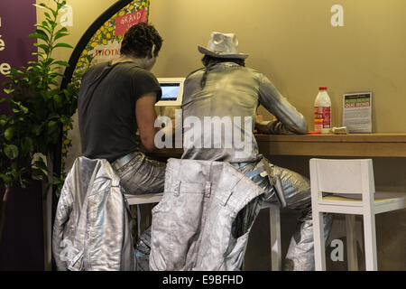 Stand Still, immobile, gli artisti di strada / esecutori avente un periodo di riposo e relax tempo prendendo una pausa al bar, coffee shop,Parigi. Foto Stock