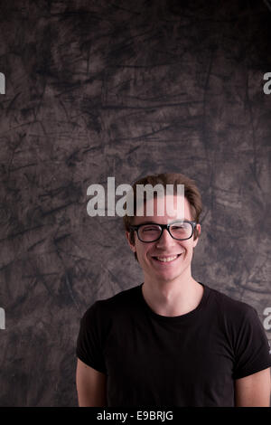 Da stupidi guy sorridente a noi di fronte a una lavagna Foto Stock