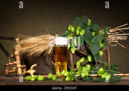 Bicchiere di birra con materie prime per la produzione di birra Foto Stock