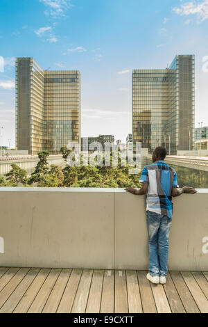 Giovane uomo contemplando il cortile interno della nuova biblioteca nazionale di Francia e alla Bibliothèque nationale de France Foto Stock