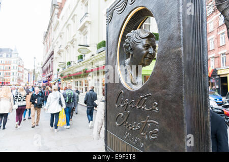 LONDON, Regno Unito - 26 ottobre: Agatha Christie libro commemorativo sagomato con strada trafficata in background. Il memoriale di bronzo era svelare Foto Stock