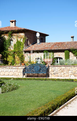 French Country House in stile classico con piante di vite e un prato verde Foto Stock