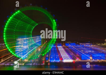 Zoomburst degli edifici London Eye e Old County Hall, lungo il Tamigi con facciata illuminata in blu a Londra UK in ottobre - effetto astratto Foto Stock