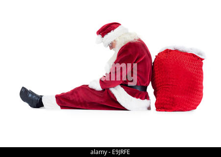 Santa siede appoggiò sulla sua borsa Foto Stock